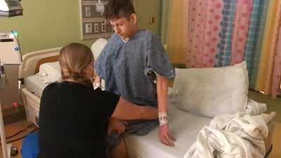 Boy receiving post surgery therapy