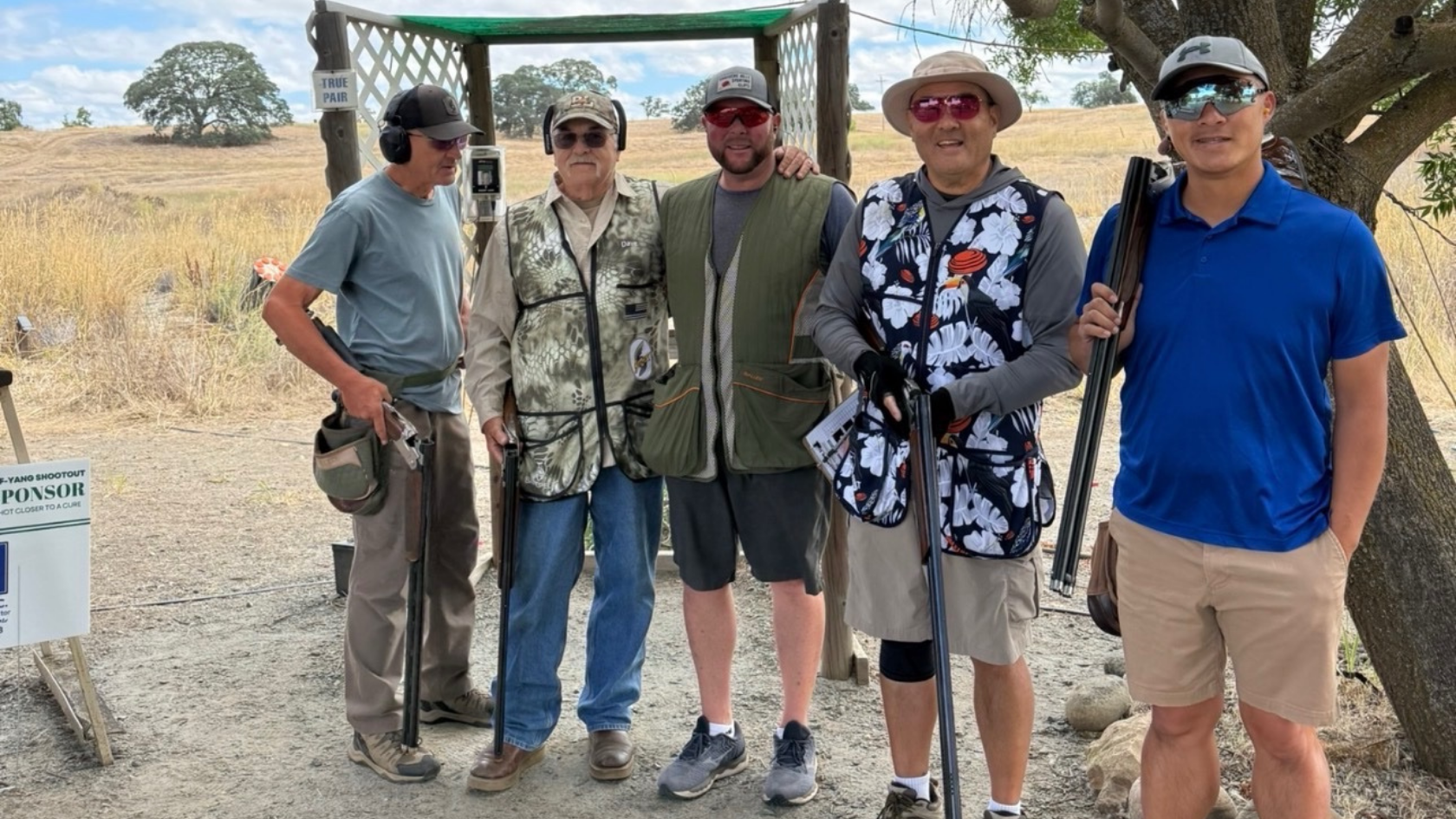 Five participants pose with shotguns at the SYS Shootout sporting clays fundraiser.