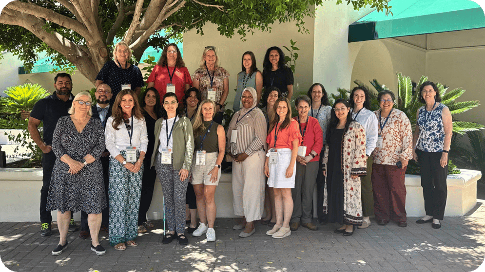 Group of PWS clinicians and research professionals pose together outdoors at a professional meeting.