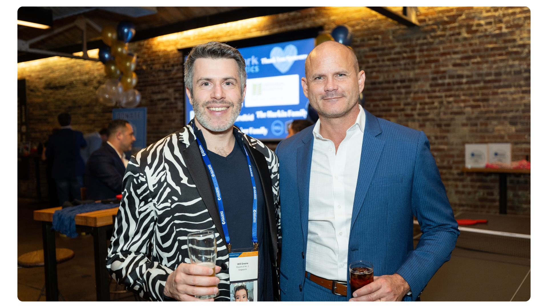 Two FPWR conference attendees posing together at an evening reception.