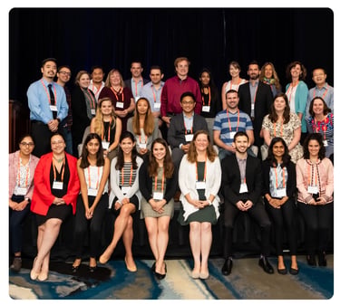 Group of researchers and conference attendees posing together at an FPWR event.