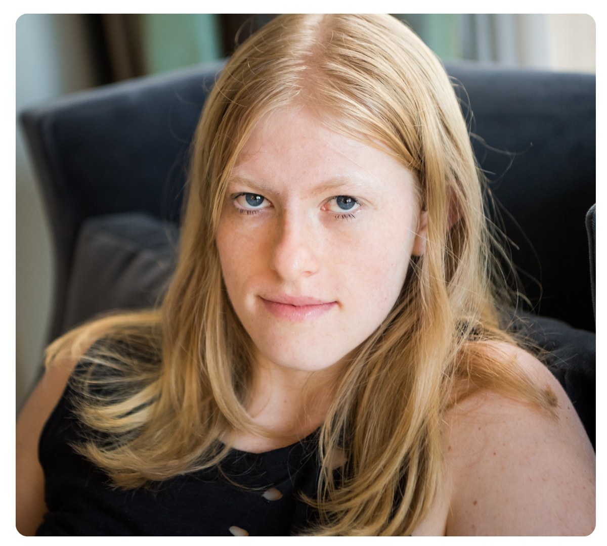 Young woman with long red hair looking at the camera.